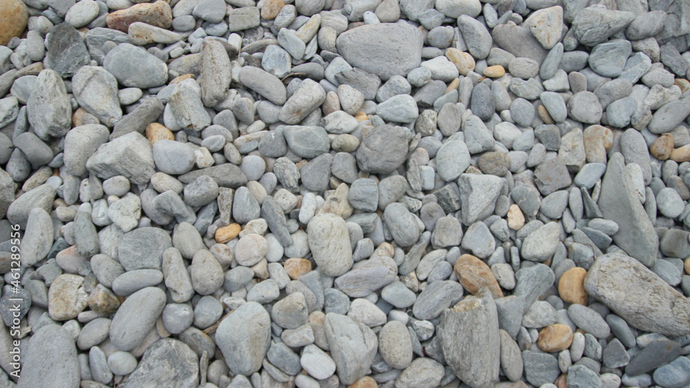 Smooth, gray rocks lining the shore of South Portland Maine. Worn down by the ocean. Smooth, gray rocks lining the shore of South Portland Maine. Worn down by the ocean.