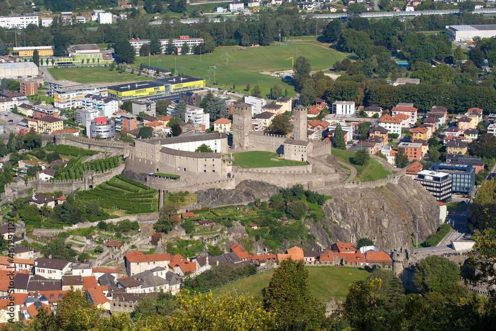 Aerial view over the City of Bellinzona with mountains in the background on a sunny late summer afternoon. Photo taken September 12th, 2021, Bellinzona, Switzerland.