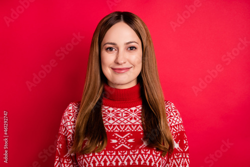 Portrait of attractive cheerful brown-haired girl wearing cozy festal jumper isolated over bright red color background