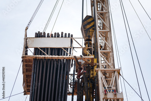 Derrick structure of oil drilling rig with daytime sky background. Heavy industrial equipment and object photo. photo