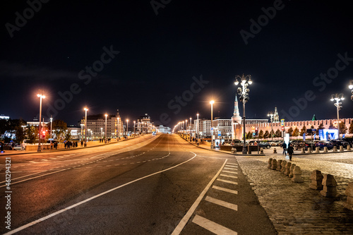 night landscape of the city with illuminated old houses  churches and a fortress wall 