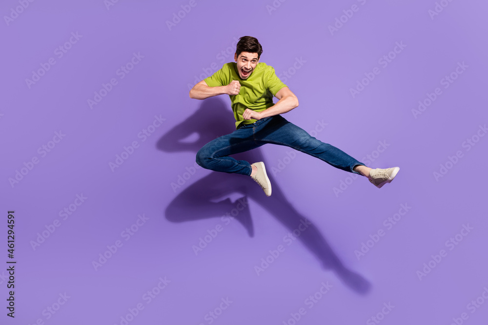 Full length body size view of nice cheerful guy jumping fighting isolated over vivid violet purple color background