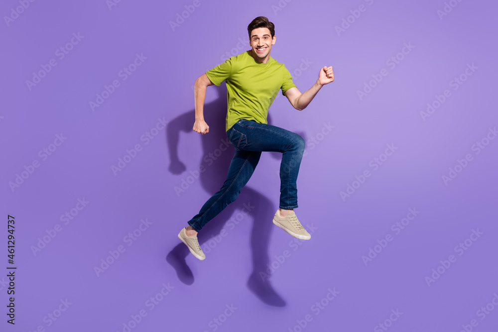 Full length body size view of attractive cheerful guy jumping running isolated over vivid violet purple color background