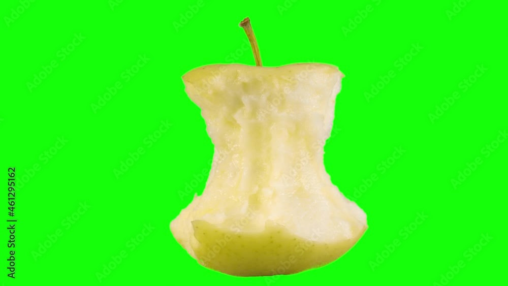 An apple core rotates on a green background. Minimalistic animated design style. Elements concept blank background template. The art of minimal motion design. An apple core rotates on a green background. Minimalistic animated design style. Elements concept blank background template. The art of minimal motion design.