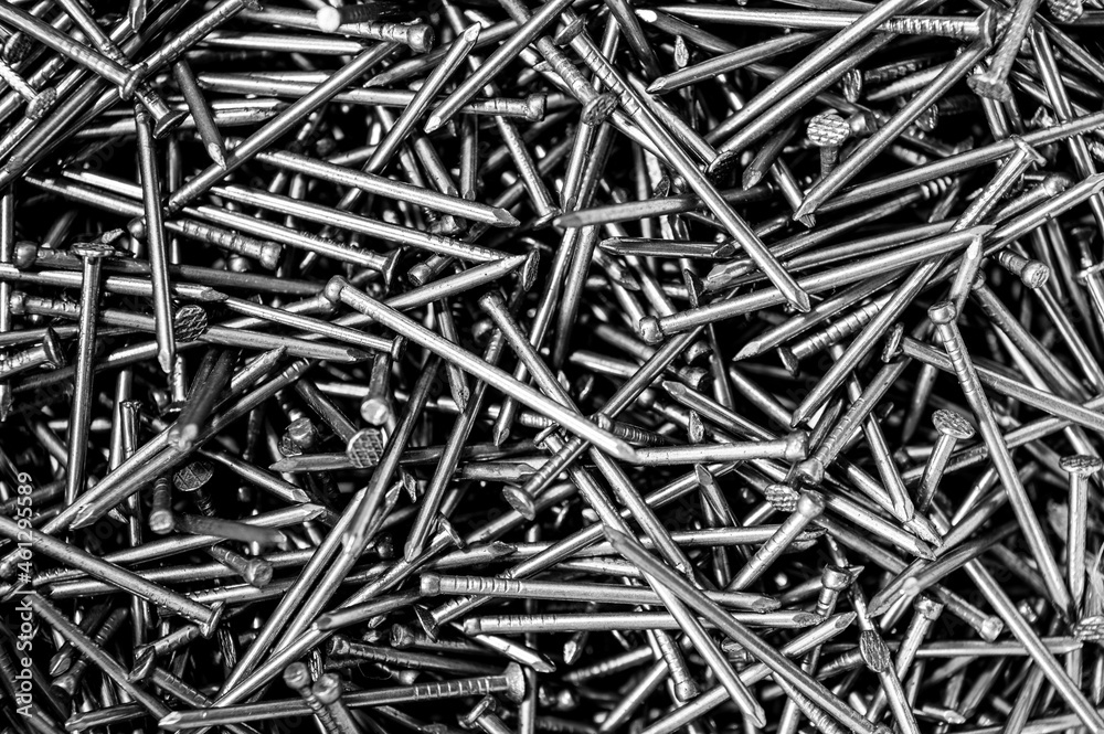 A pile of nails in black and white. Close up of the mess in the toolbox. A pile of nails in black and white. Close up of the mess in the toolbox.