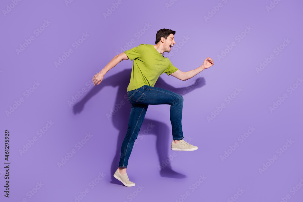 Fototapeta premium Full length body size view of attractive cheerful guy jumping running isolated over bright violet purple color background