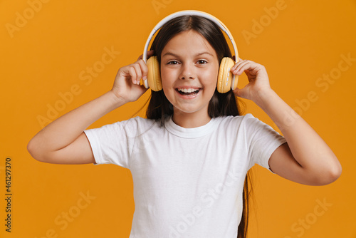White brunette girl smiling while listening music with headphones