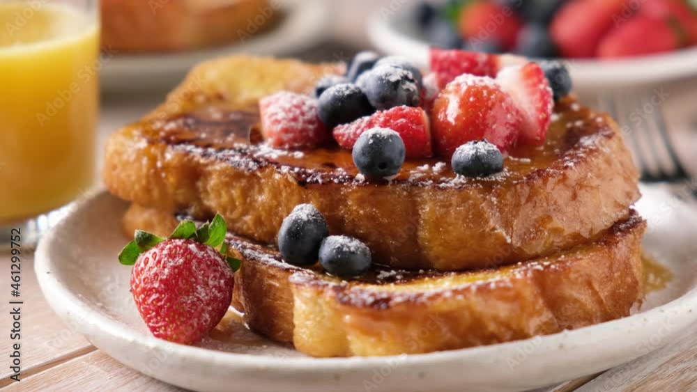 Sweet french toast with berries and powdered sugar on plate, closeup view Sweet french toast with berries and powdered sugar on plate, closeup view