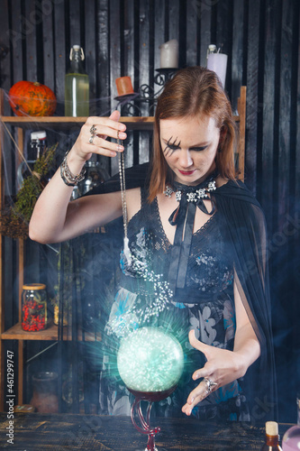 Young beautiful witch conjure at Halloween 