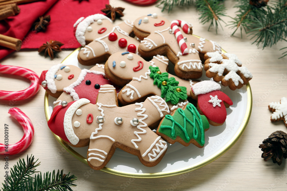 Delicious Christmas cookies, candies and fir branches on beige table