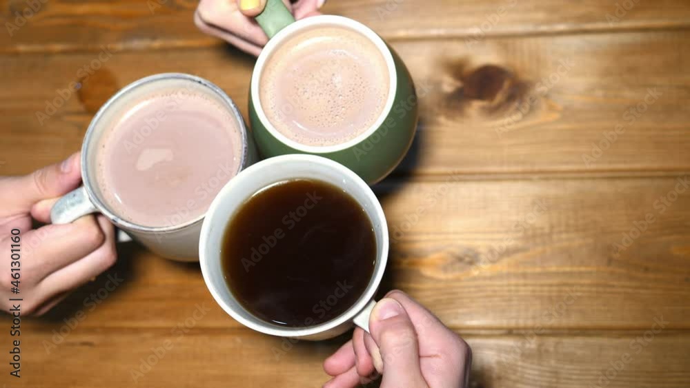 Group of friends are drinking coffee in a cafe. People drinking coffee high angle view Group of friends are drinking coffee in a cafe. People drinking coffee high angle view