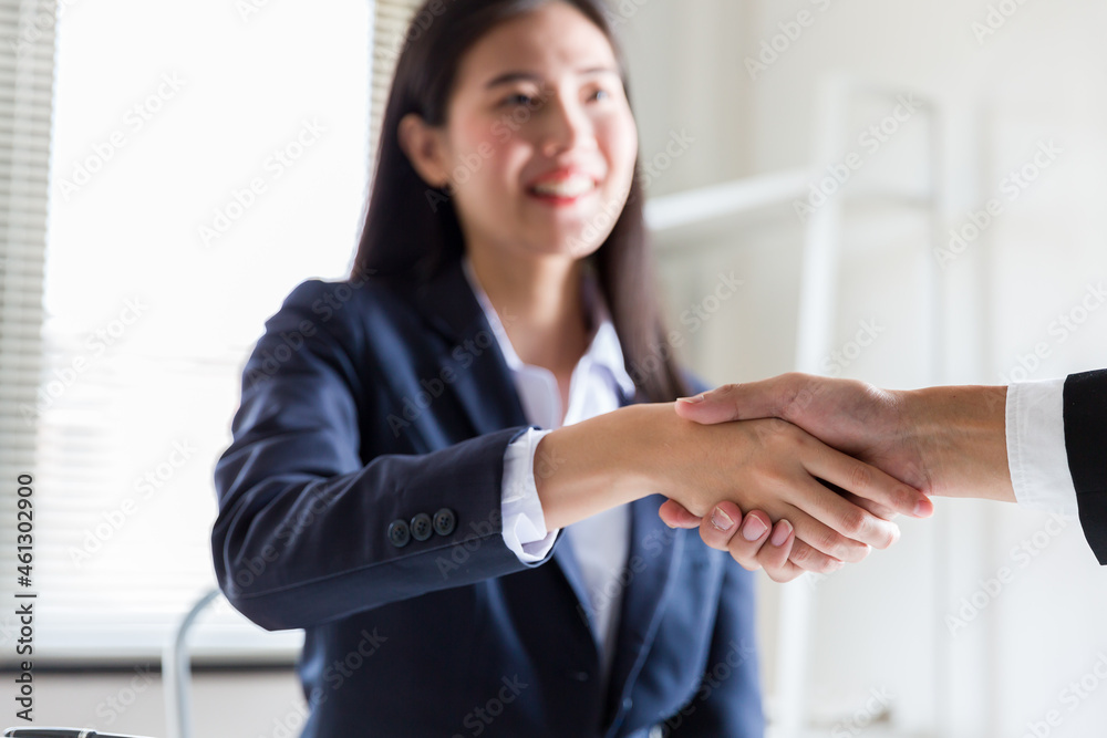 Business woman greeting with shake hands to congratulate after agreement with partner. Two business partners greeting together Business woman greeting with shake hands to congratulate after agreement with partner. Two business partners greeting together