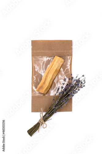 Palo Santo tree sticks in a craft bag with a bouquet of dry lavender against white background. Incense for meditation, aromatherapy, ceremonies and rituals, cleansing and healing. Isolate, close-up.