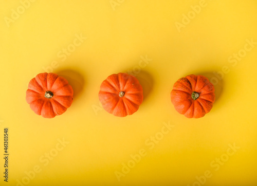 Halloween pumpkin on yellow background