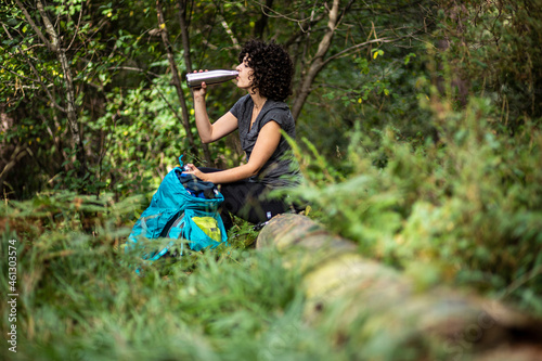 girl drinking in the woods