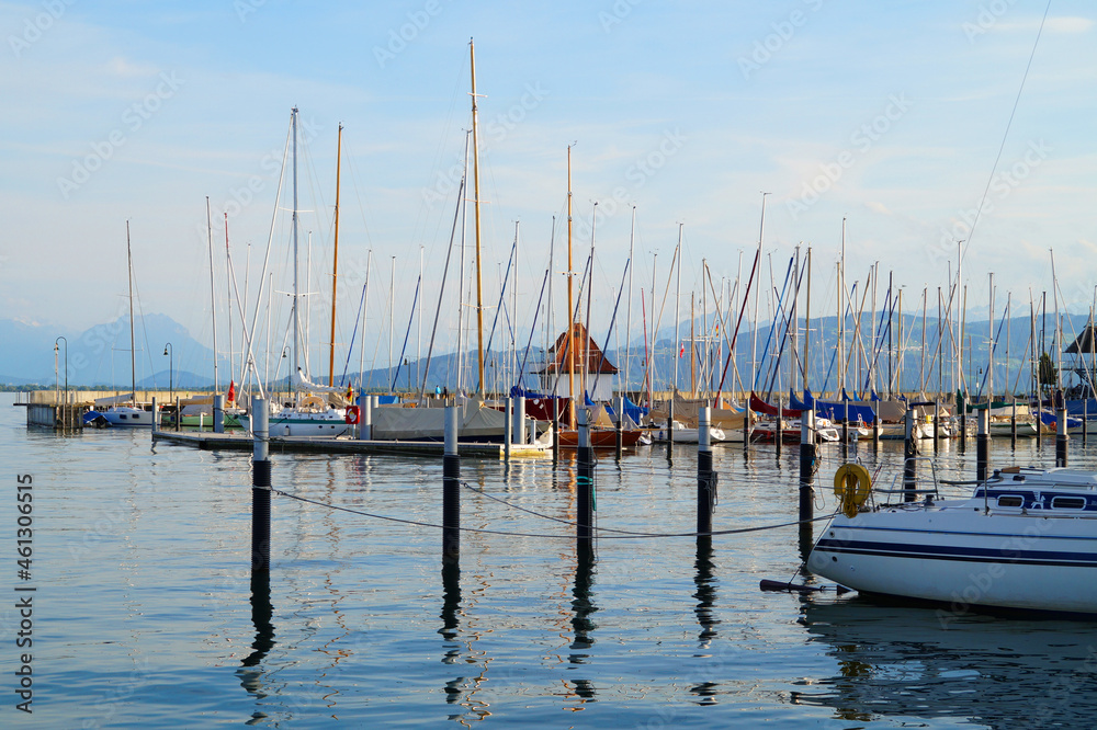 a beautiful marina of Lindau island on lake Constance (Bodensee) with the sunlit Alps in the background, Germany a beautiful marina of Lindau island on lake Constance (Bodensee) with the sunlit Alps in the background, Germany