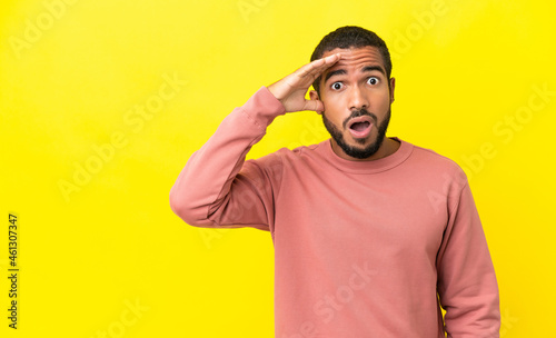 Young latin man isolated on yellow background has realized something and intending the solution