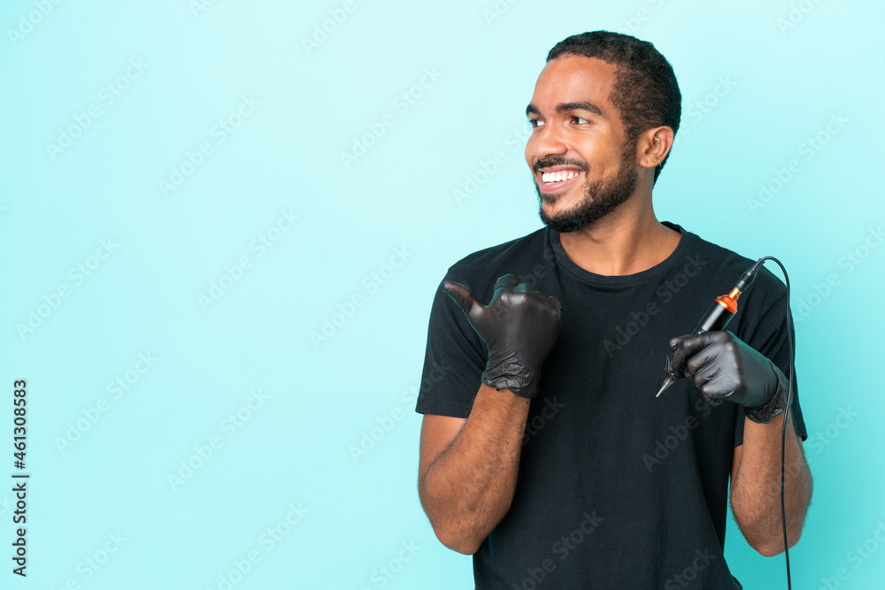 Tattoo artist Ecuadorian man isolated on blue background pointing to the side to present a product