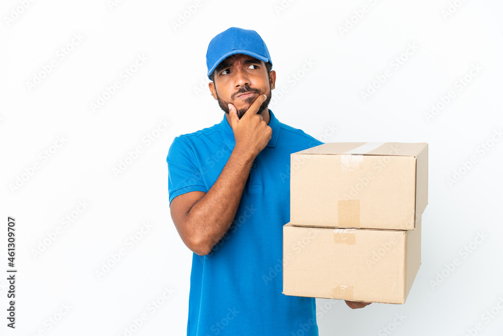 Delivery Ecuadorian man isolated on white background having doubts Delivery Ecuadorian man isolated on white background having doubts
