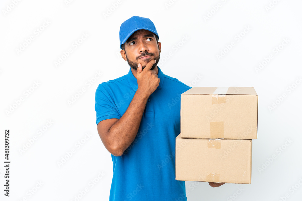 Delivery Ecuadorian man isolated on white background and looking up Delivery Ecuadorian man isolated on white background and looking up