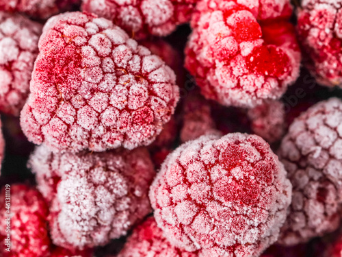 Beautiful background of red frozen raspberries.
