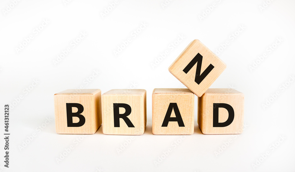 Brand symbol. The concept word 'brand' on wooden cubes on a beautiful white table, white background. Business and brand concept. Copy space. Brand symbol. The concept word 'brand' on wooden cubes on a beautiful white table, white background. Business and brand concept. Copy space.