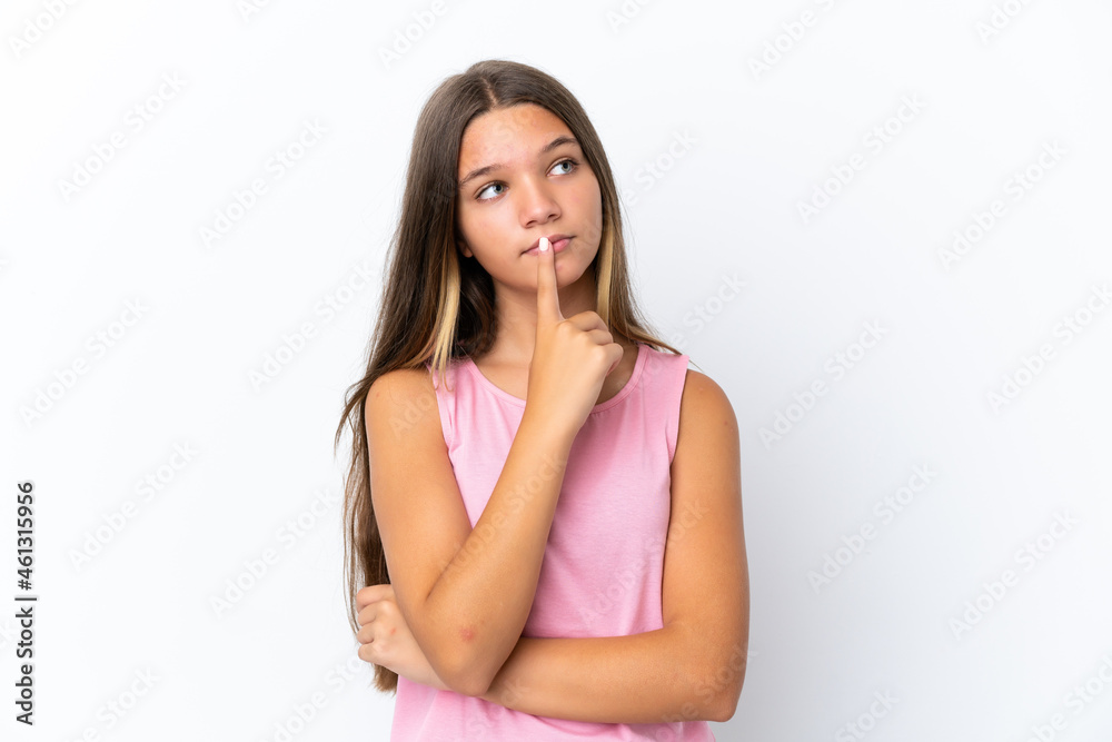 Little caucasian girl isolated on white background having doubts while looking up Little caucasian girl isolated on white background having doubts while looking up