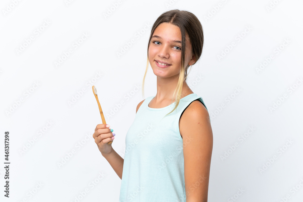 Little caucasian girl holding a toothbrush isolated on white background smiling a lot Little caucasian girl holding a toothbrush isolated on white background smiling a lot