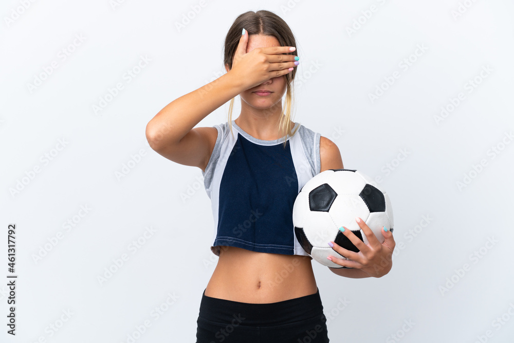 Little caucasian girl playing football isolated on white background covering eyes by hands. Do not want to see something