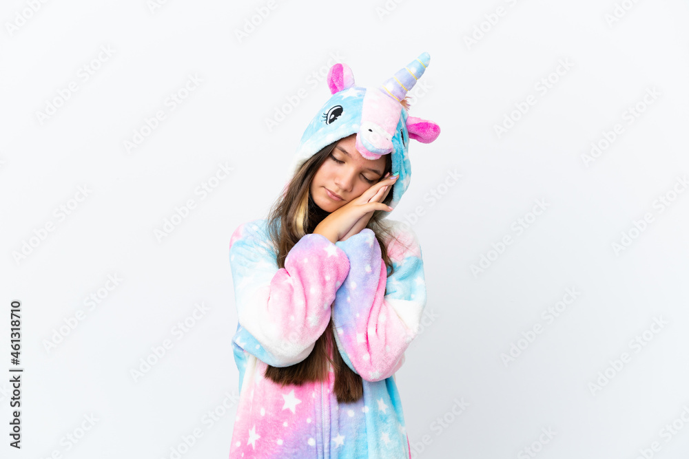 Little caucasian girl wearing unicorn pajama isolated on white background making sleep gesture in dorable expression Little caucasian girl wearing unicorn pajama isolated on white background making sleep gesture in dorable expression