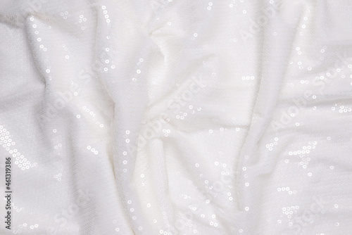 White sequin background. White shiny sequin fabric.