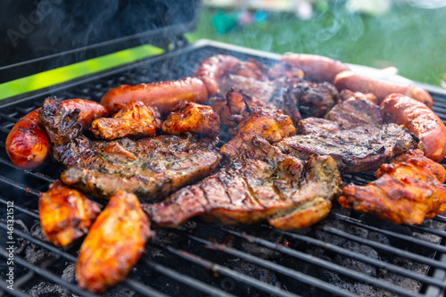 Grilled pork meat and sausages on the barbecue