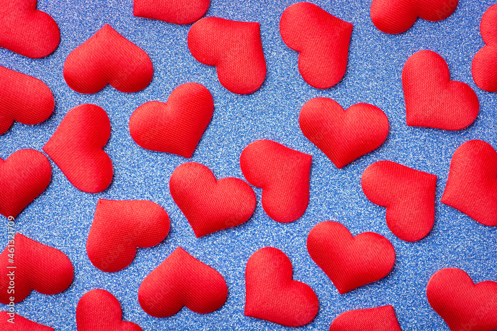 Many red hearts on blue background. Symbolic romantic love background
