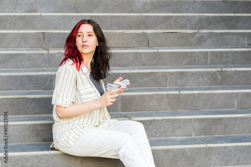 Fotografija Woman holding a reusable silicone collapsible cup