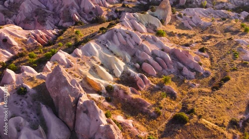 Red and Pink Rocks, Colourful Mountains, Birds eye view 4k aerial drone landscape. Dramatic geological wonder. Famous Pink Valley At Sunset, Gulludere in Cappadocia, Turkey. photo