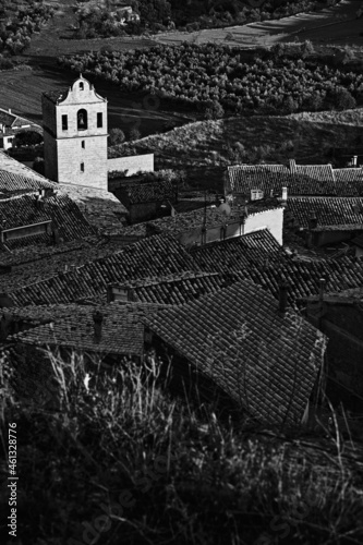 Vertical greyscale shot of a bell tower in Comarca Matarrania, Teruel province, Spain photo