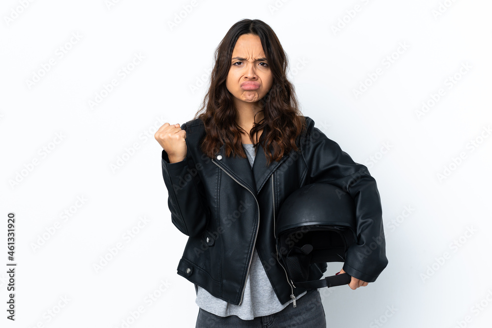 Young woman holding a motorcycle helmet over isolated white background with angry gesture Young woman holding a motorcycle helmet over isolated white background with angry gesture