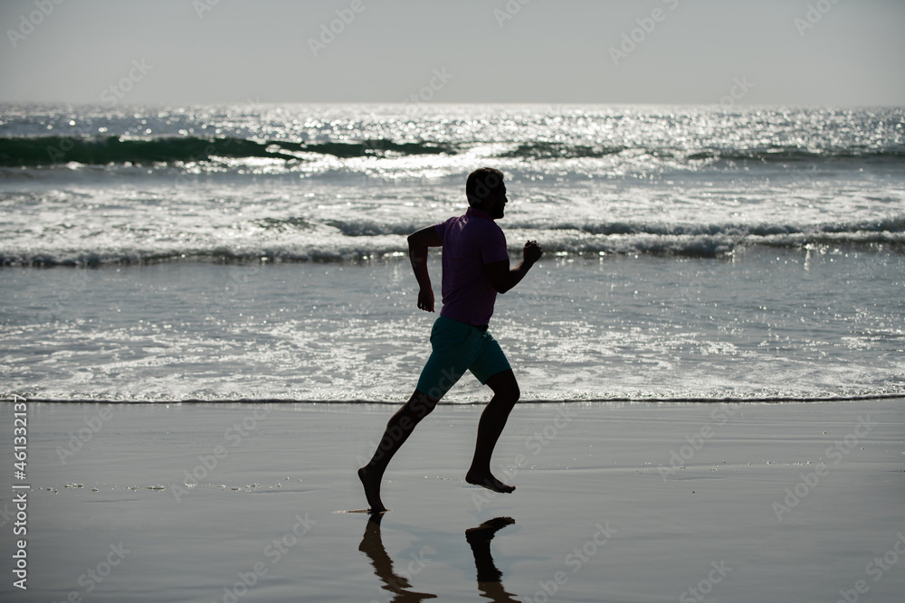 silhouette of sporty man runner sprinting on beach outdoor, achievement silhouette of sporty man runner sprinting on beach outdoor, achievement
