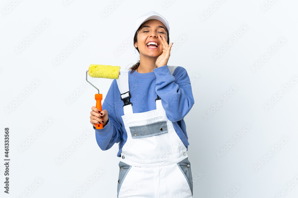 Painter woman over isolated white background shouting and announcing something Painter woman over isolated white background shouting and announcing something