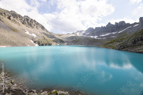 Amazing hiking day in one of the most beautiful area in Switzerland called Pizol in the canton of Saint Gallen. A wonderful view at the alpine lake called Wildsee with a tent by the lake. Epic view.