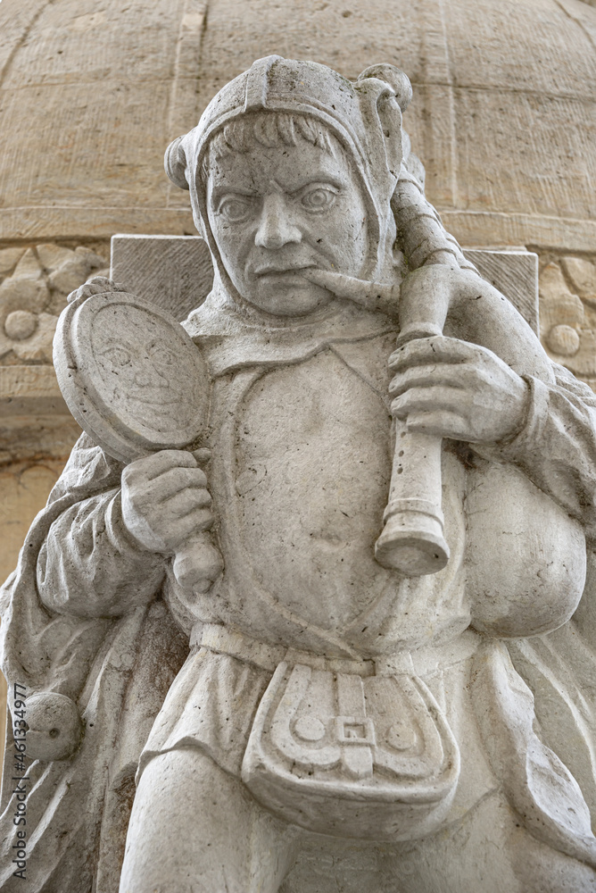 Ancient statue of buffoon or jester at the back of Magdeburger Roland Knight statue in front of Old City Hall (Rathaus), Magdeburg, Saxony Anhalt, Germany, closeup, details.