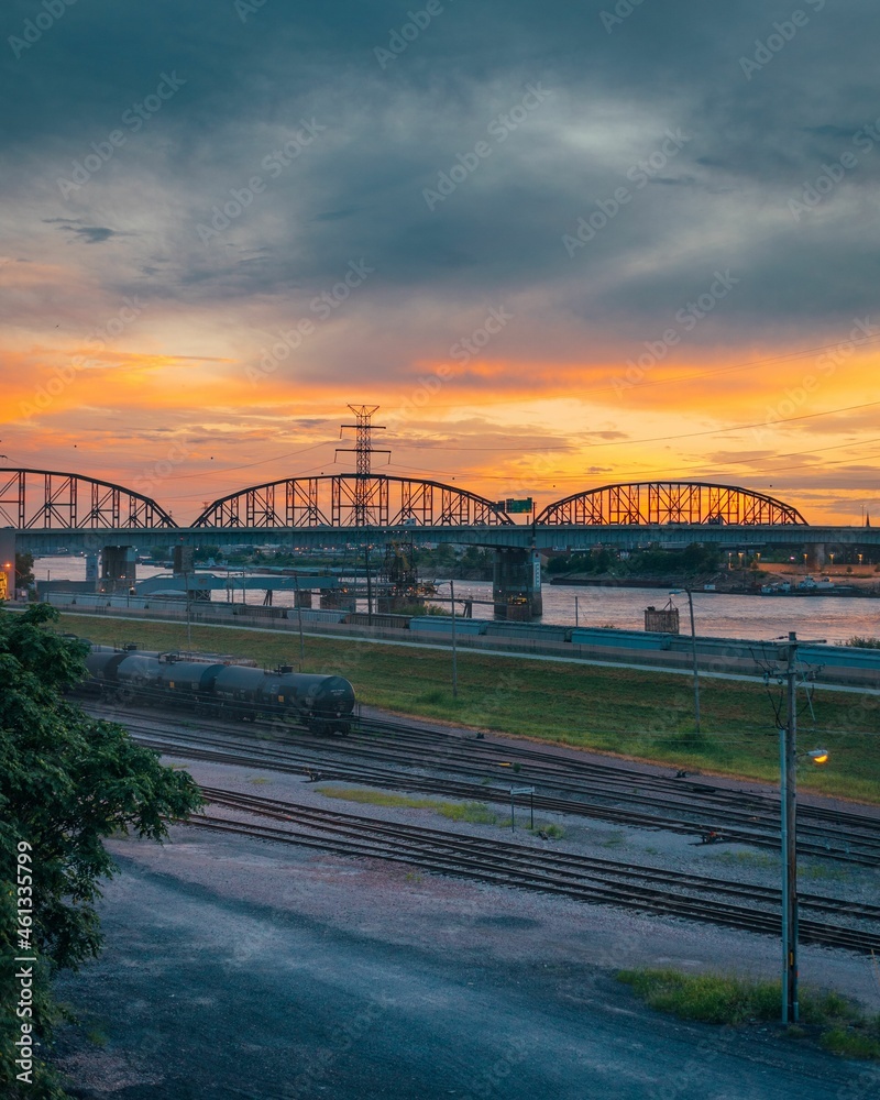Obraz premium Sunset over railroad tracks and the Mississippi River, in East St. Louis, Illinois