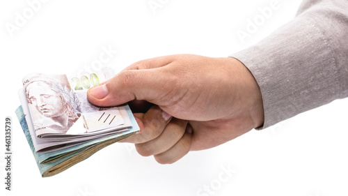 businessman hand offering Brazilian money wad, grand prize or salary concept.