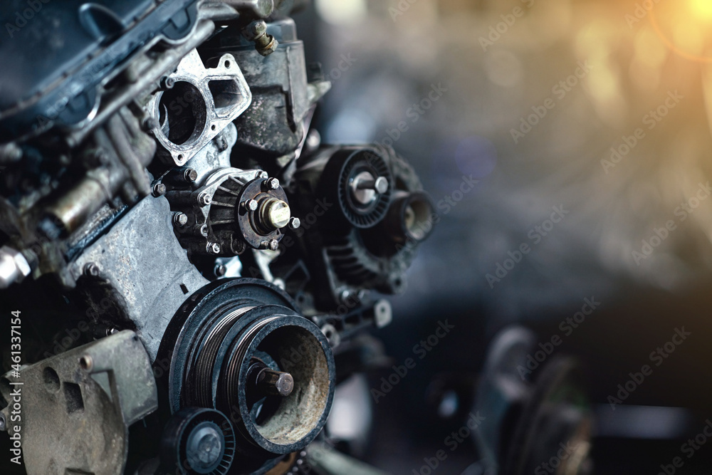 car engine repair in a car service, removed engine, crankshaft pulleys