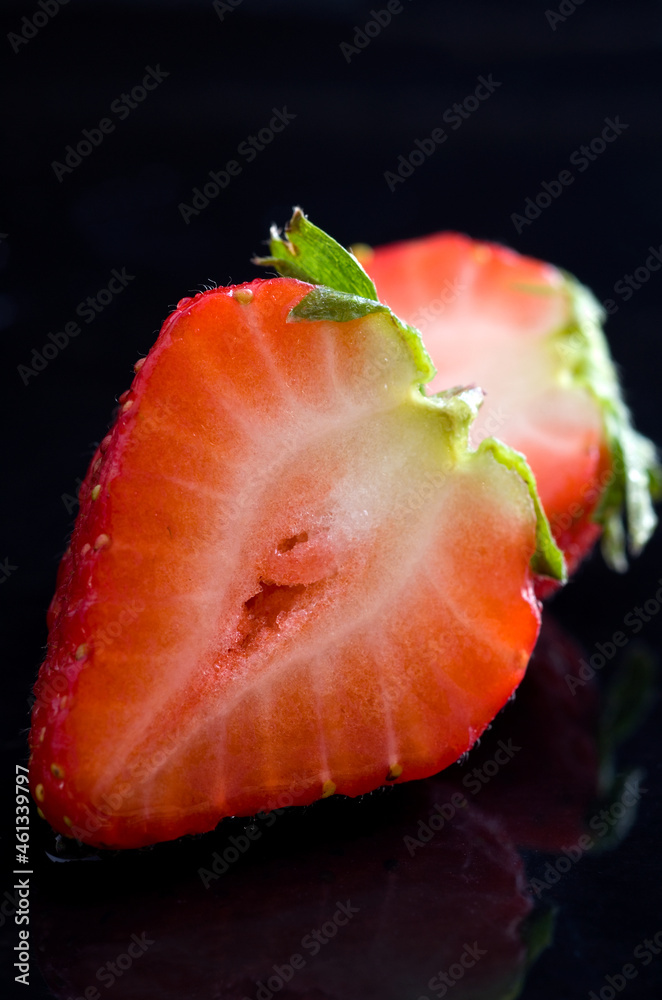 Macro Image of a Sliced Red Strawberry on Black Background Macro Image of a Sliced Red Strawberry on Black Background