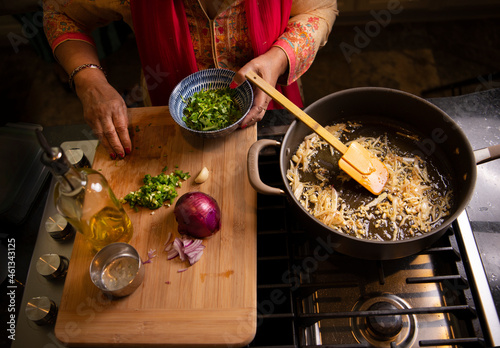 Indian woman's hands working in the kitchen preparing food