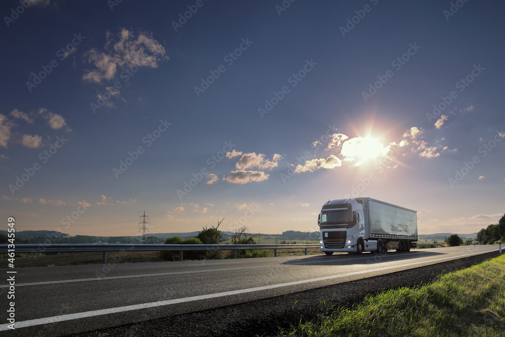 Landscape with a moving truck at sunset Landscape with a moving truck at sunset