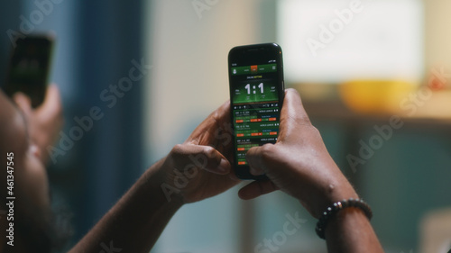Φωτογραφία African American fan placing online stakes and speaking