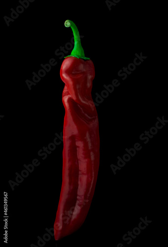 Studio shot of red chilli peppers isolated on a black background photo