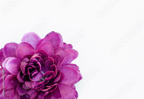 A purple fabric flower on white background 